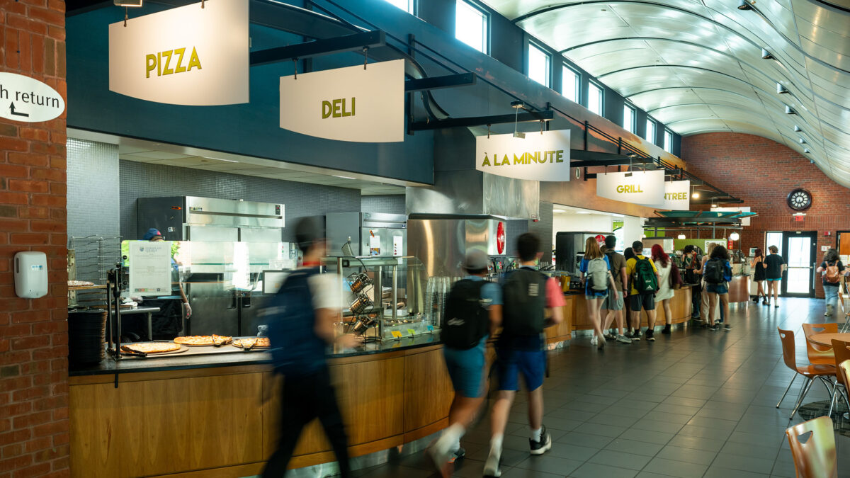 students walking through the idx student center dining hall