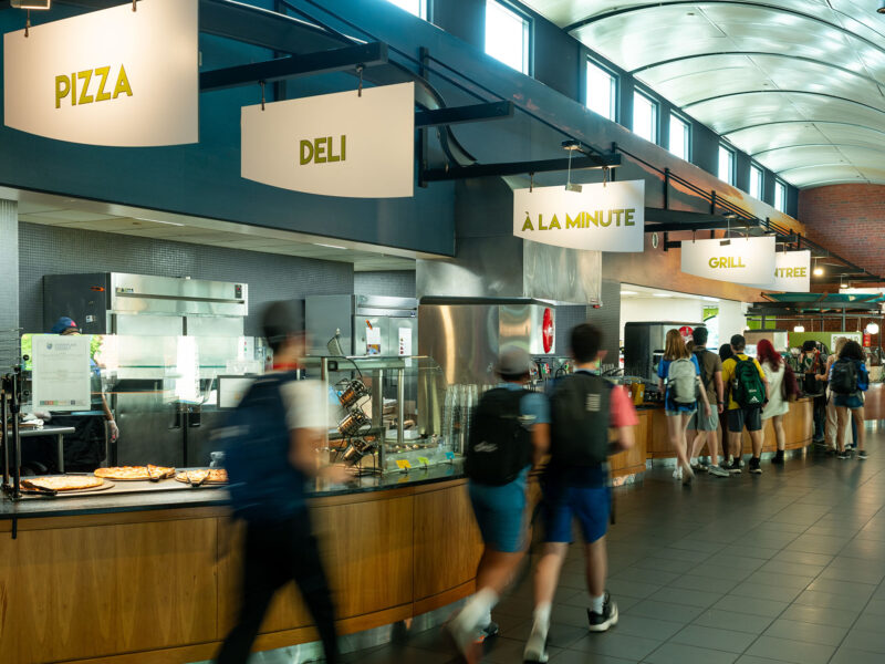 students walking through the idx student center dining hall