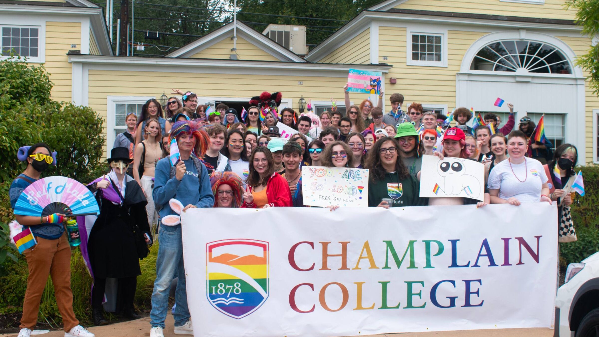 WGC Pride Parade student group photo with a Champlain College banner