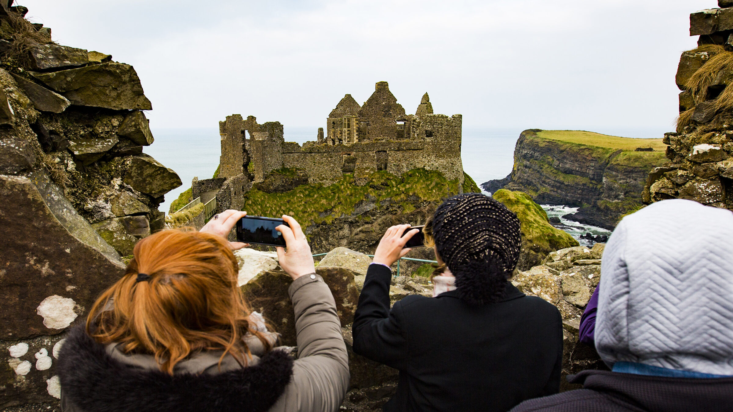 groups of students take a photo of castle ruins