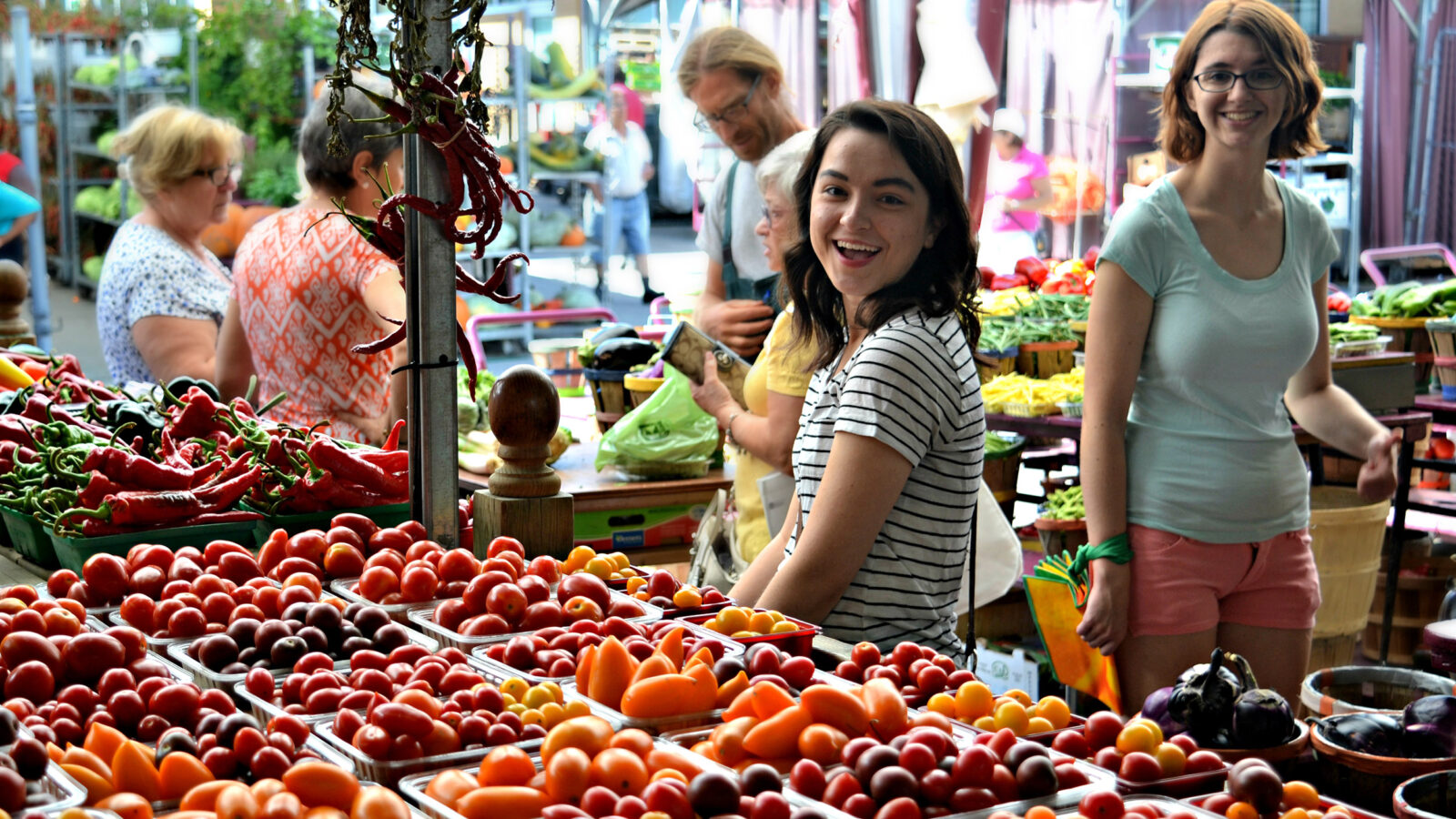 young woman at a street side fruit stand