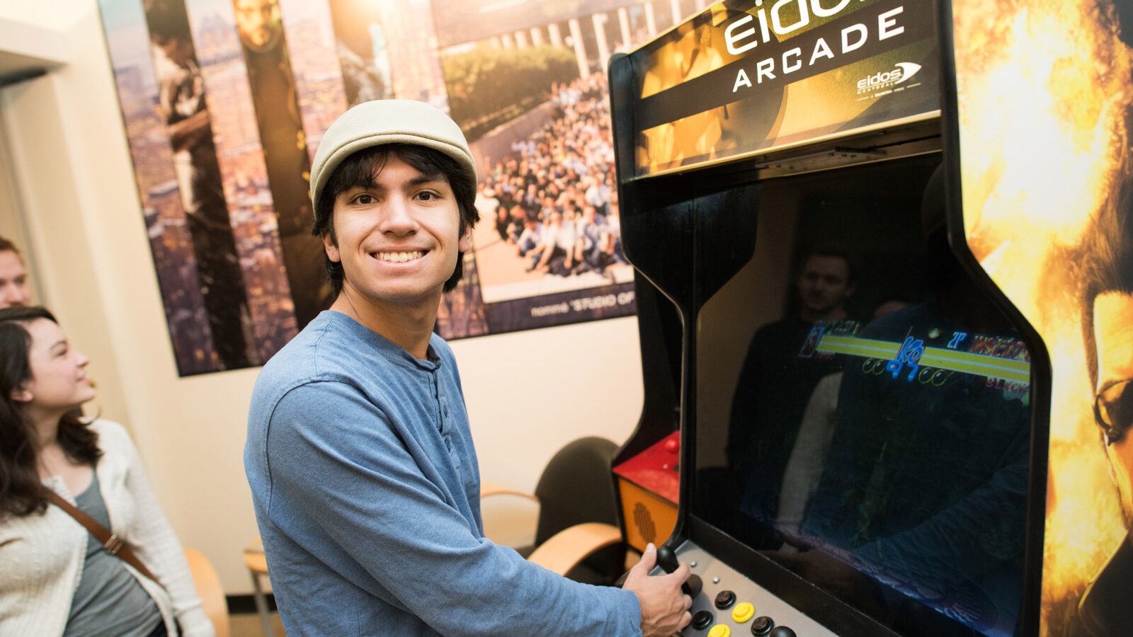 young man plays an arcade game