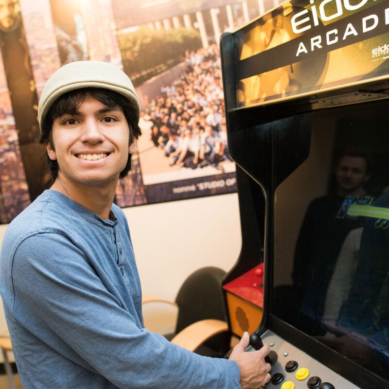 young man plays an arcade game