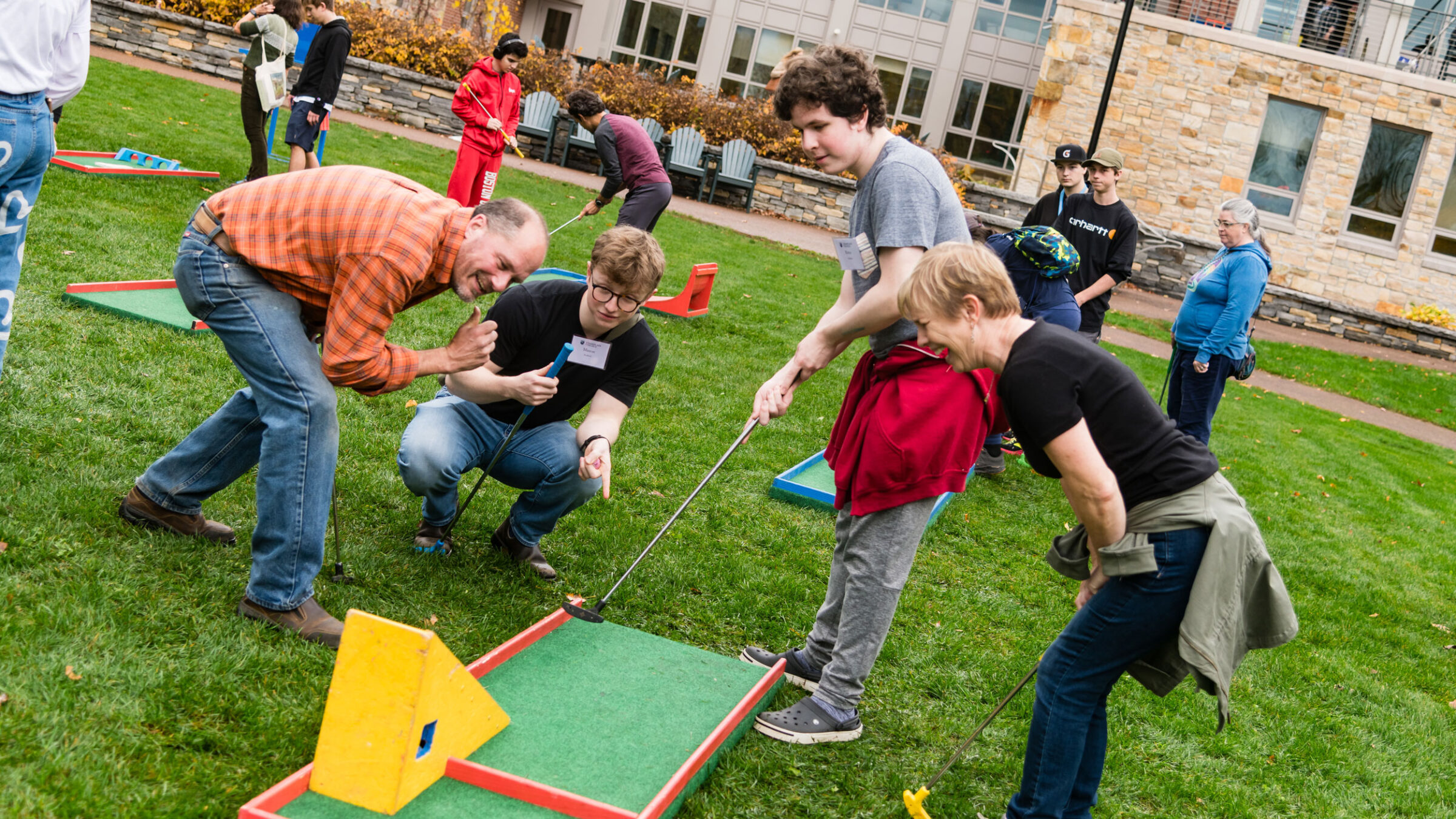 A family plays portable mini golf at Champlain Weekend.