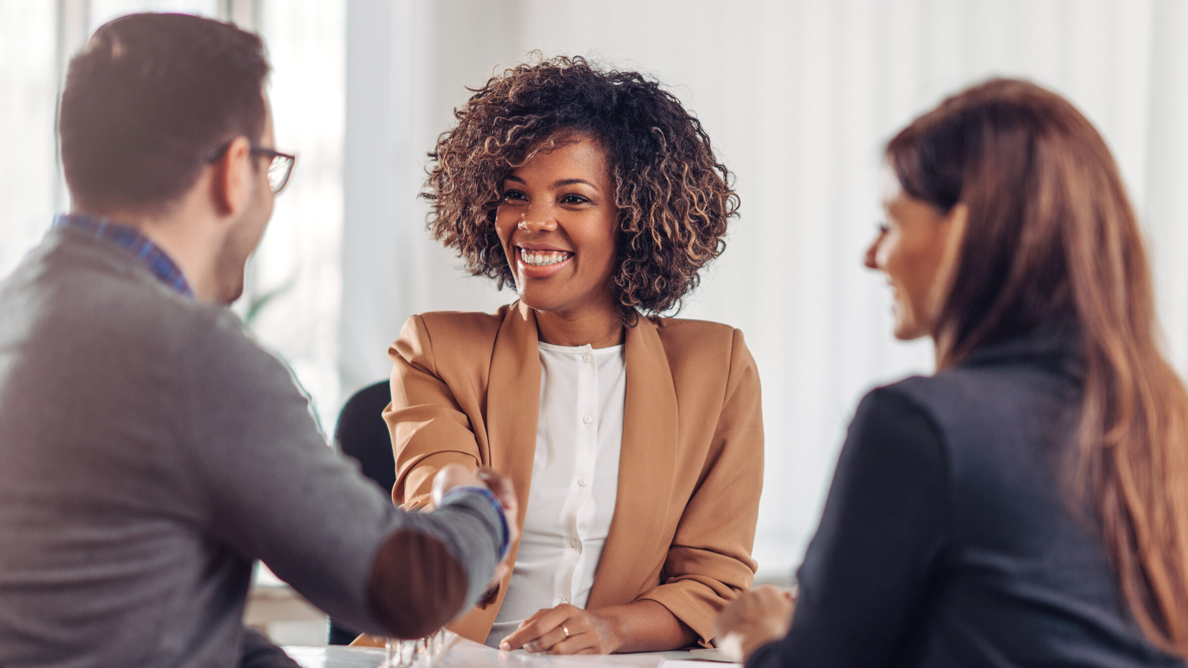 Business people shaking hands after successful meeting