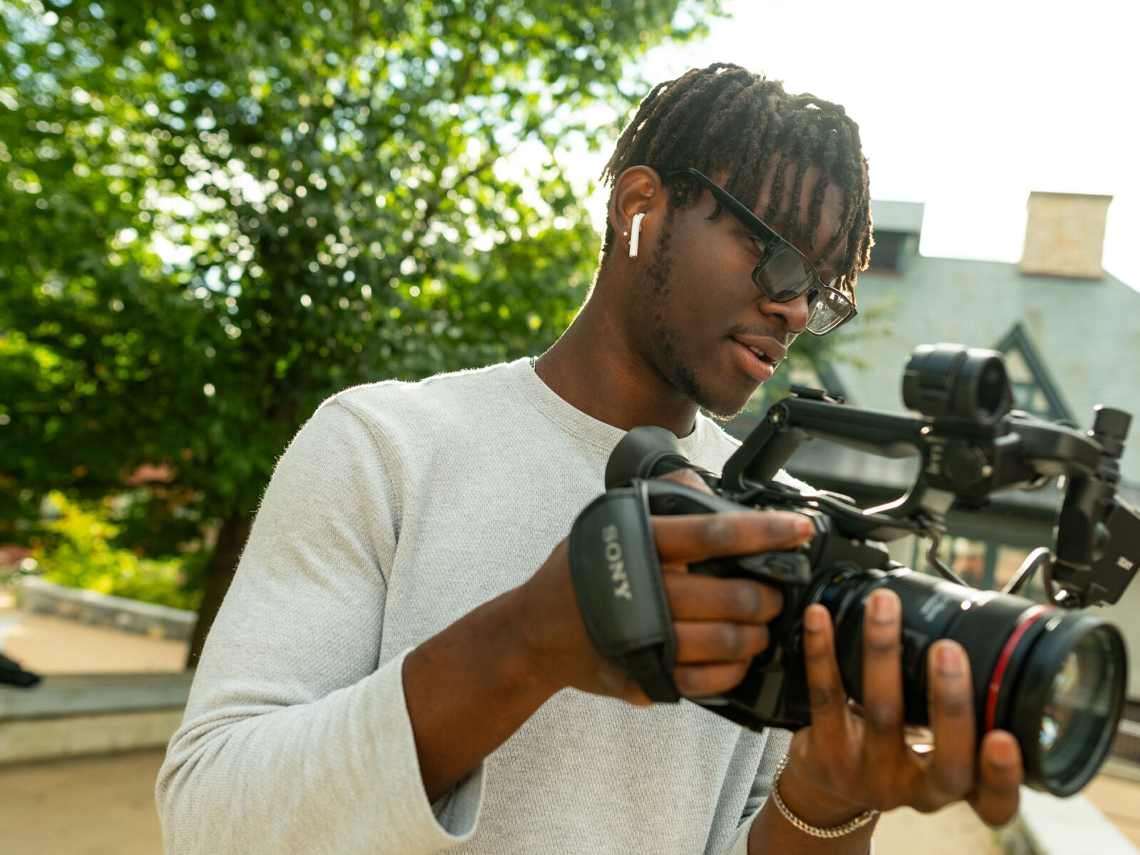 Champlain student Khellmar Daring uses a camera as a filmmaking student.