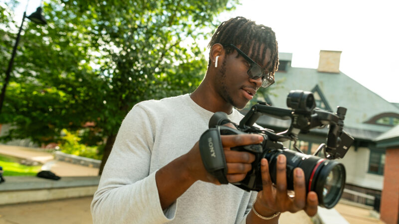 Champlain student Khellmar Daring uses a camera as a filmmaking student.