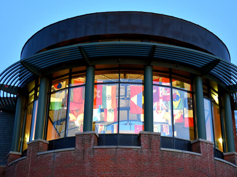 IDX from the outside of the building, international flags visible through the window