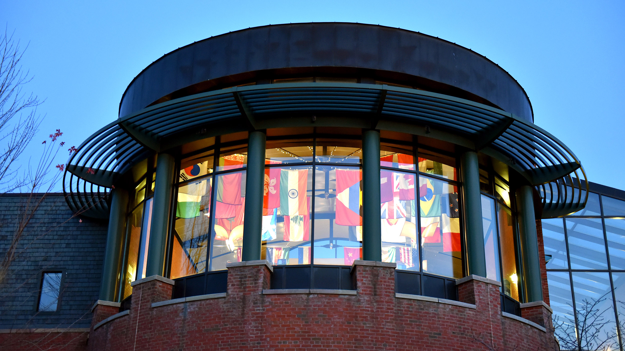 IDX from the outside of the building, international flags visible through the window