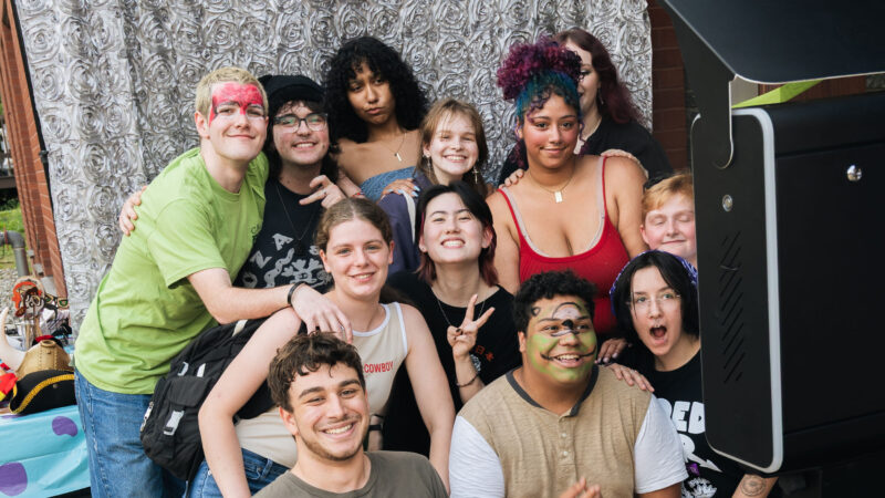 Group of students smiling and posing for a photo during an event