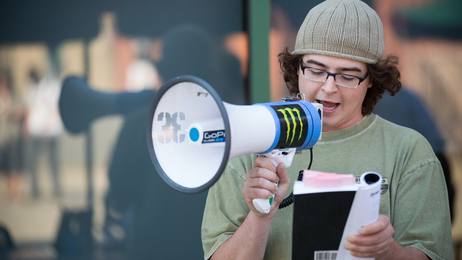 students uses a bullhorn; reads from notes