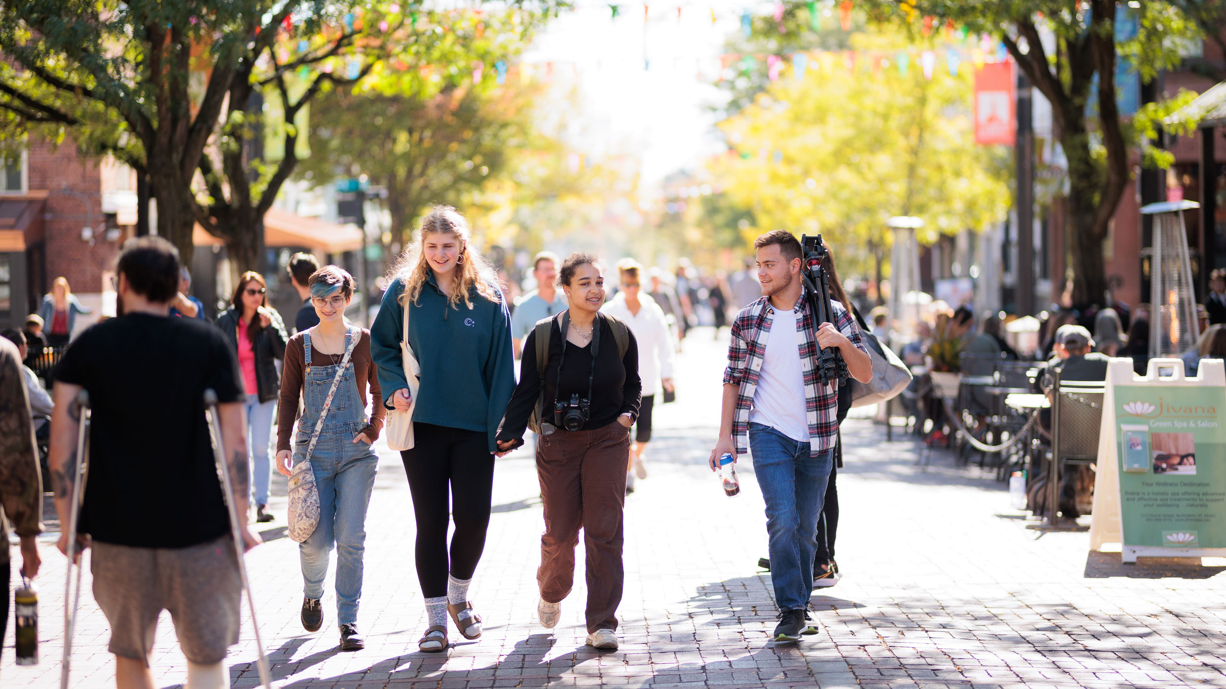 students walking down church street among groups of people in the daylight