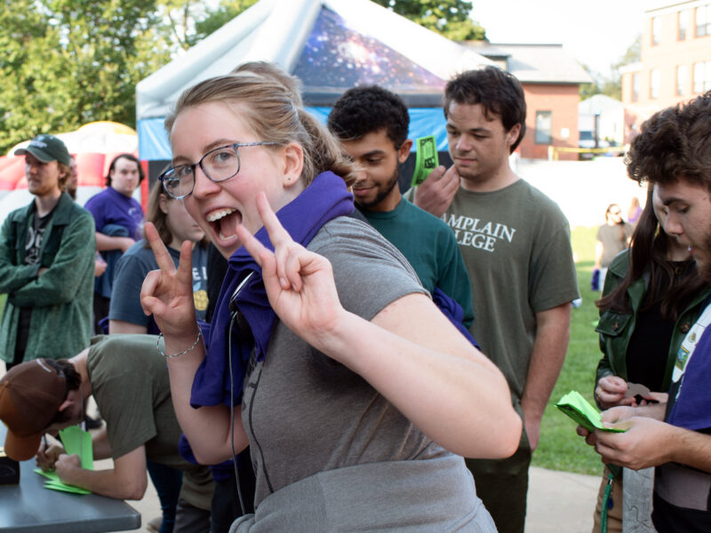 student gives the camera two peace signs