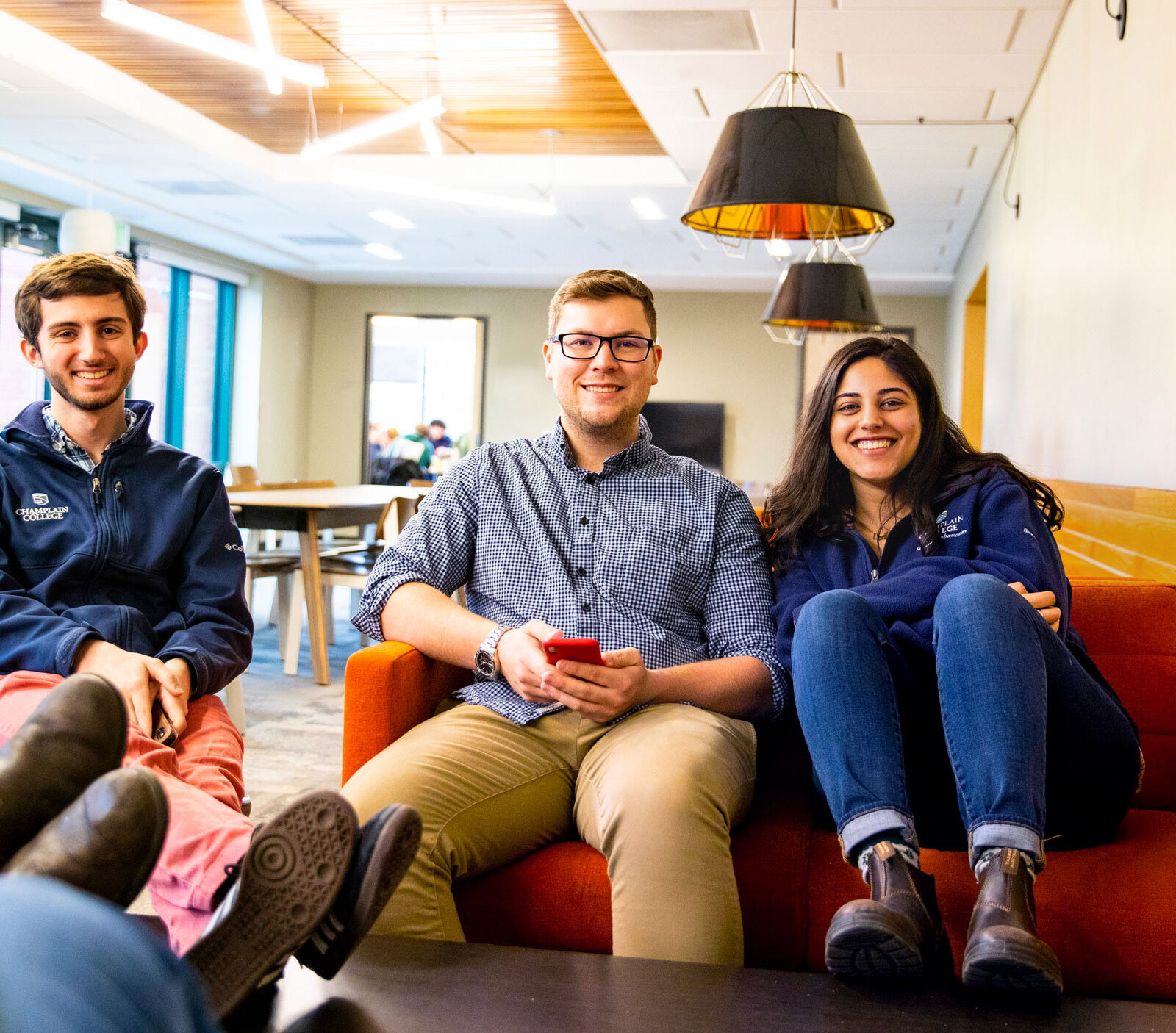 Three students hang out in the EATS Lounge at Champlain College
