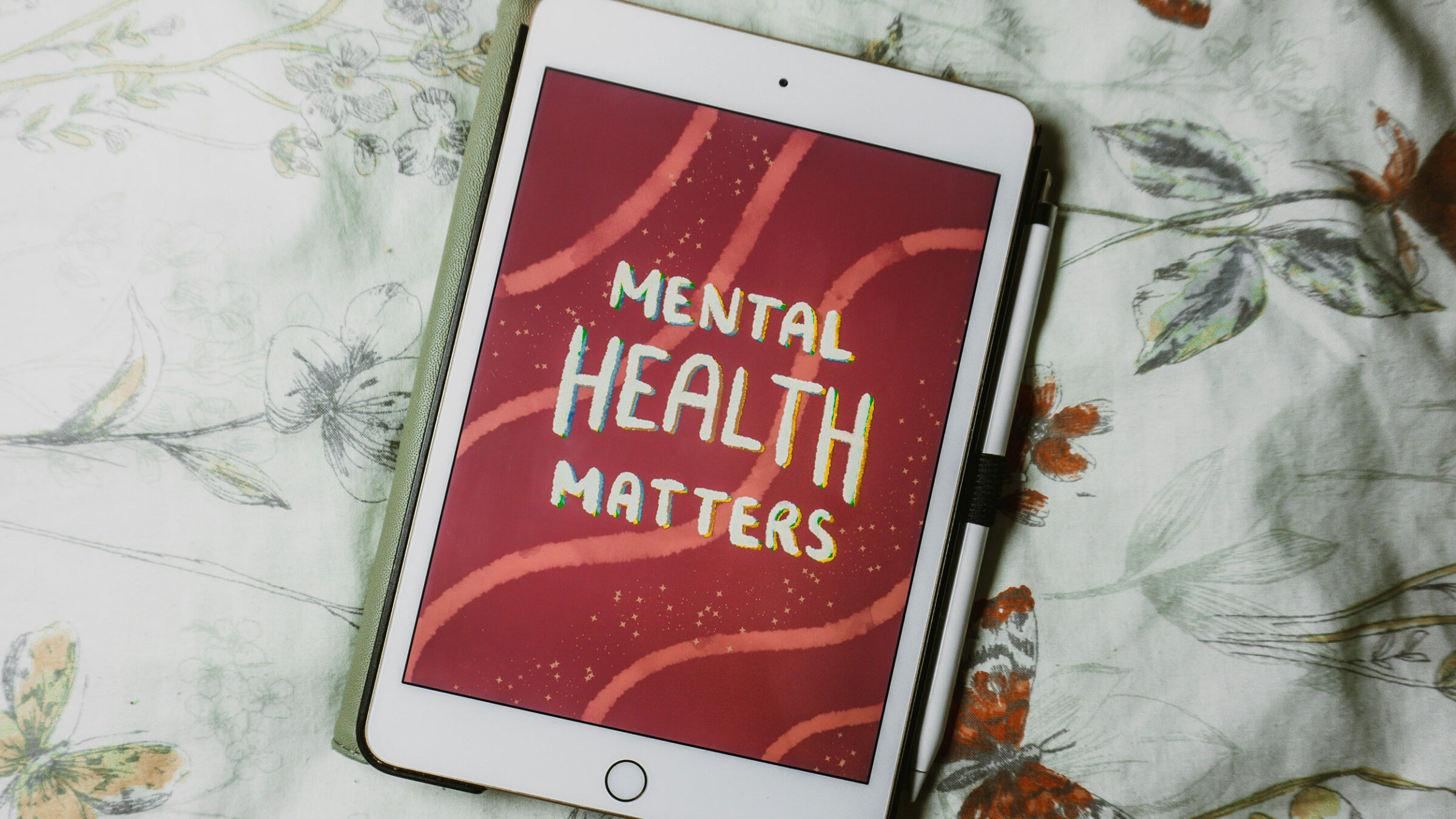an ipad shows a graphic with a red background and white text reading: "mental health matters"
