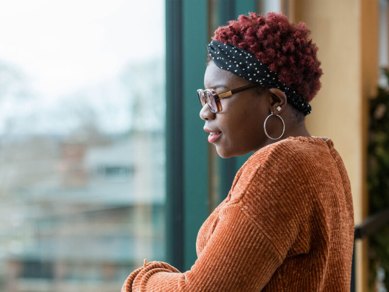 Dy'mon Guthrie looking out a window onto Champlain's campus