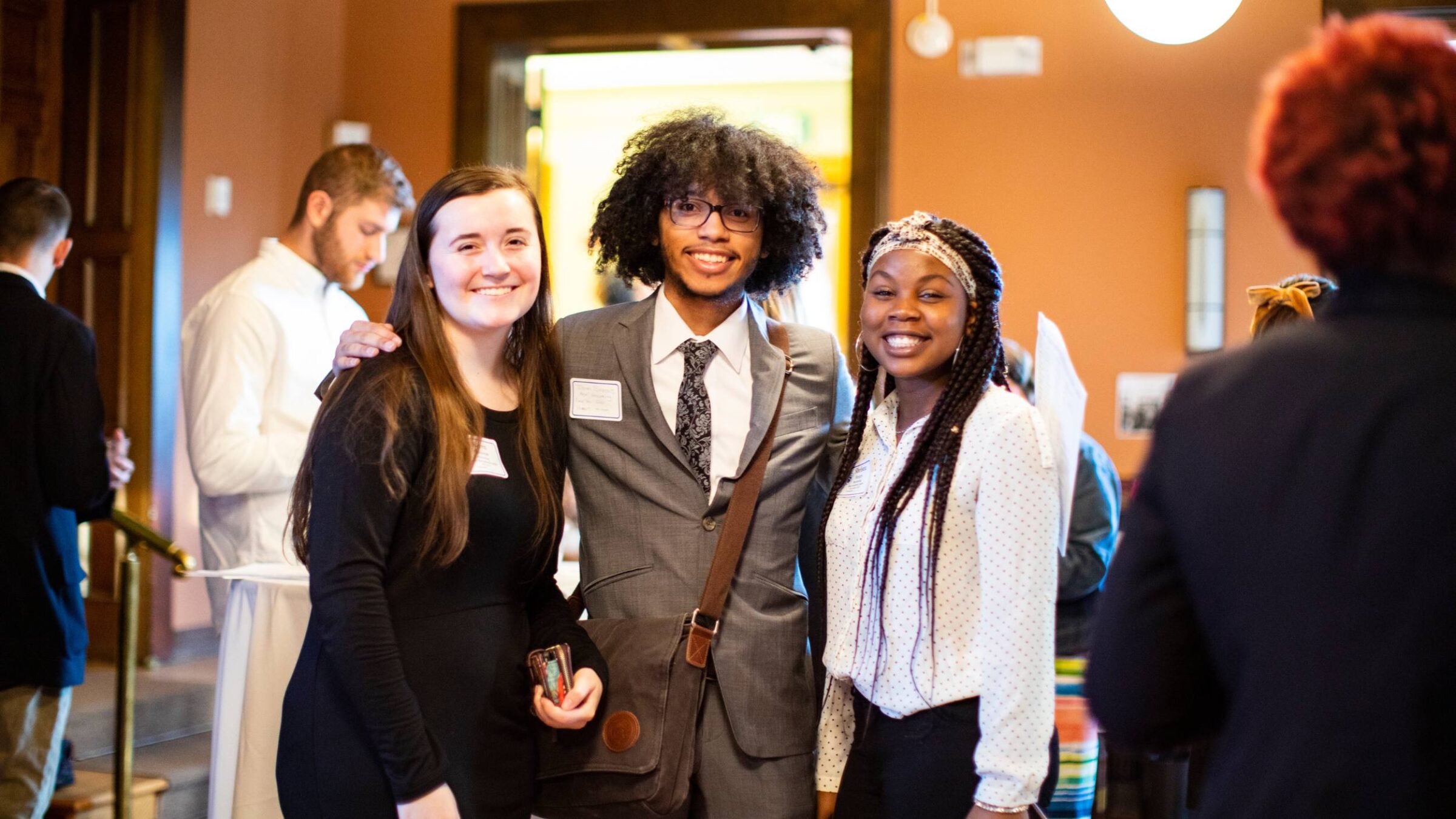 Students in business event smiling