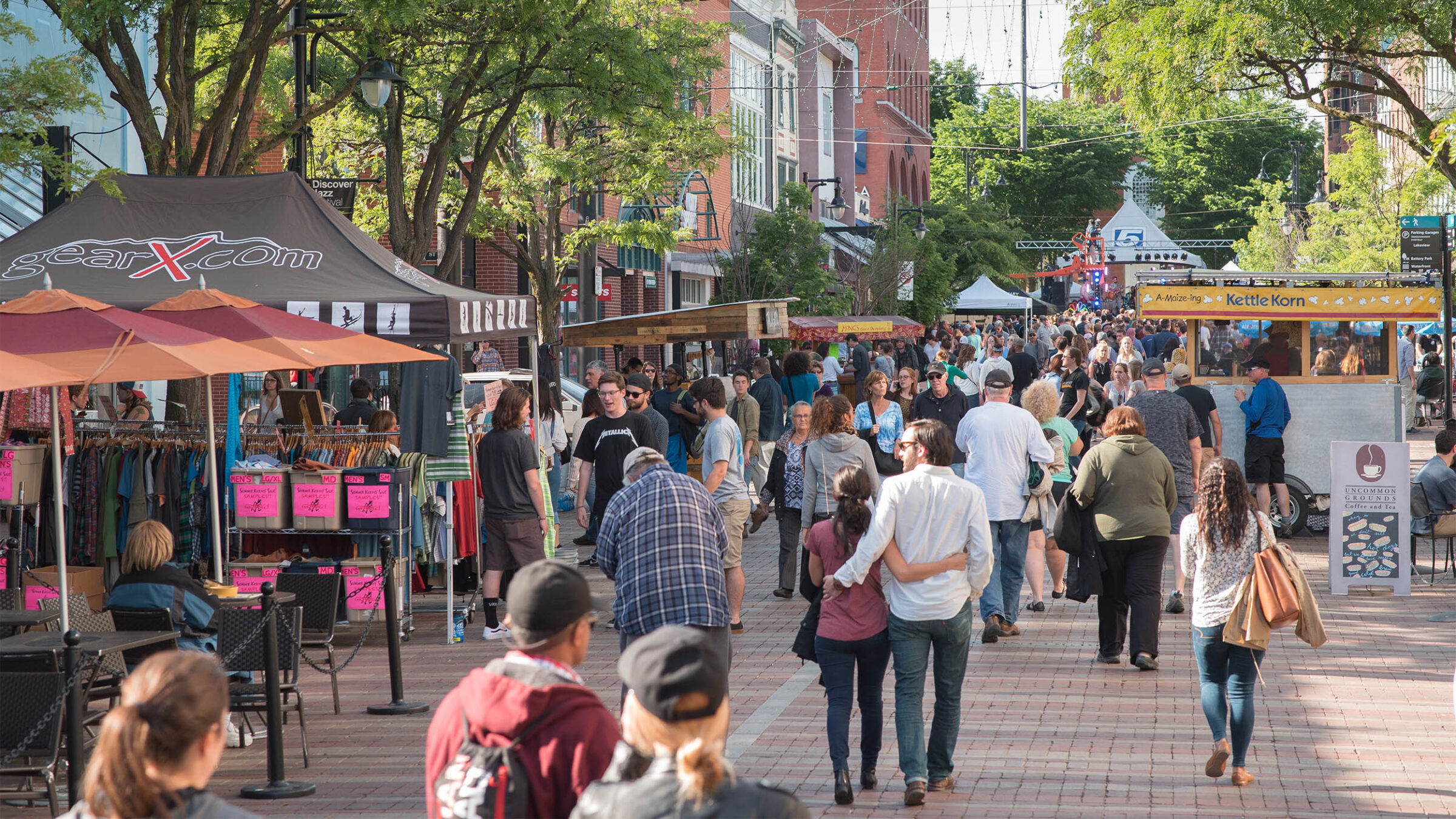 a large group of people walking down a busy Church street