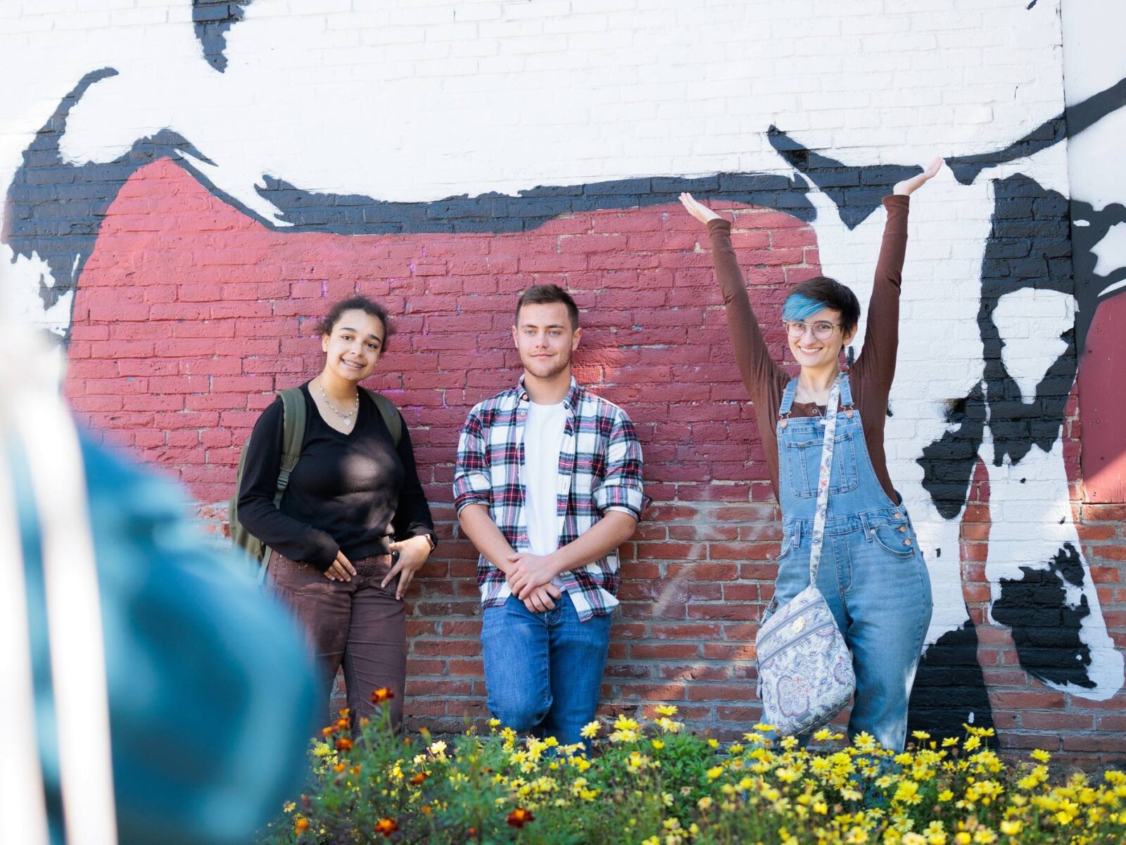 Students standing against a brick wall in downtown Burlington