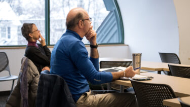 faculty listening and taking notes in a classroom