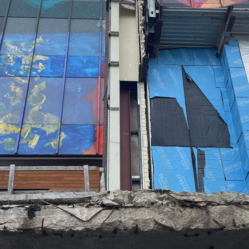 View of construction in downtown Burlington, including a small portion of a mural depicting Lake Champlain