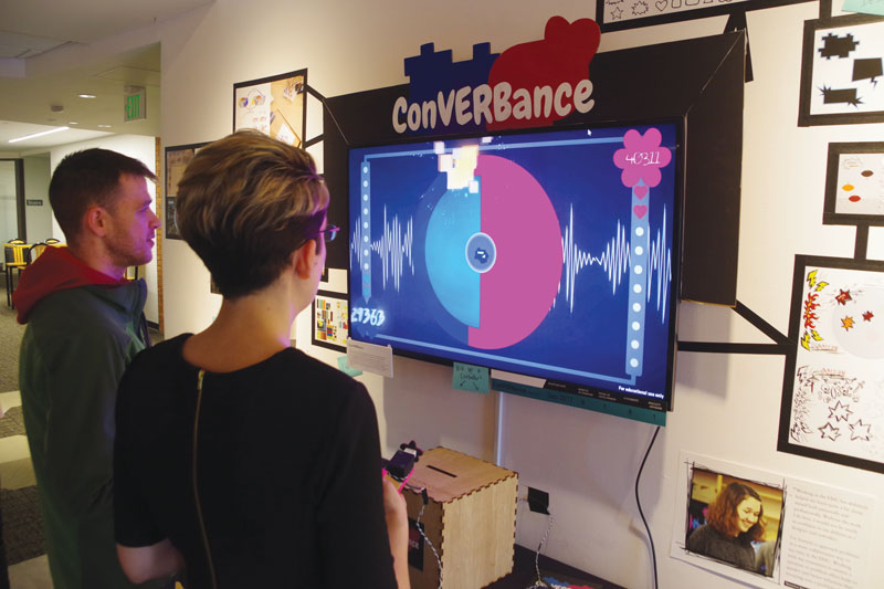 students interacting with the Creative Media Exhibition in the Champlain College Art Gallery