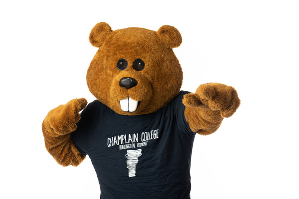 Chauncey Beaver striking a pose in front of a white background wearing a Champlain College t-shirt