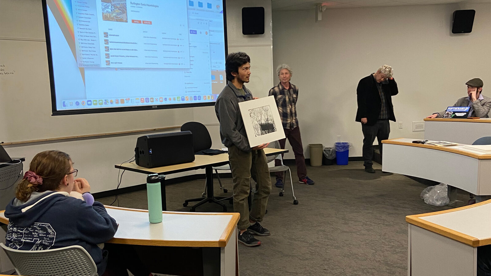 Student presenting a photograph to the class