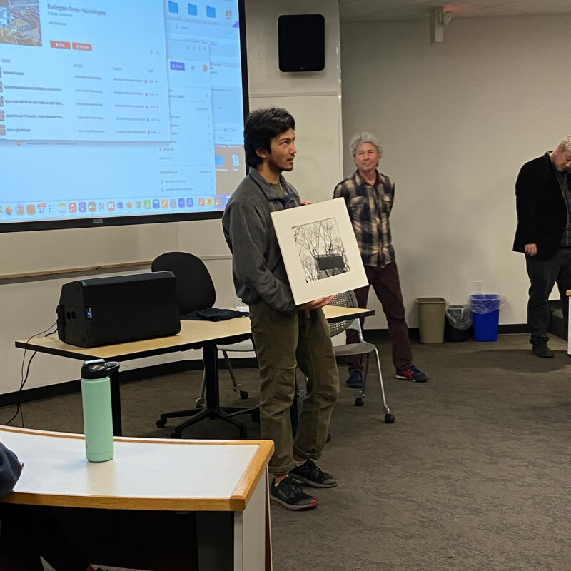 Student presenting a photograph to the class