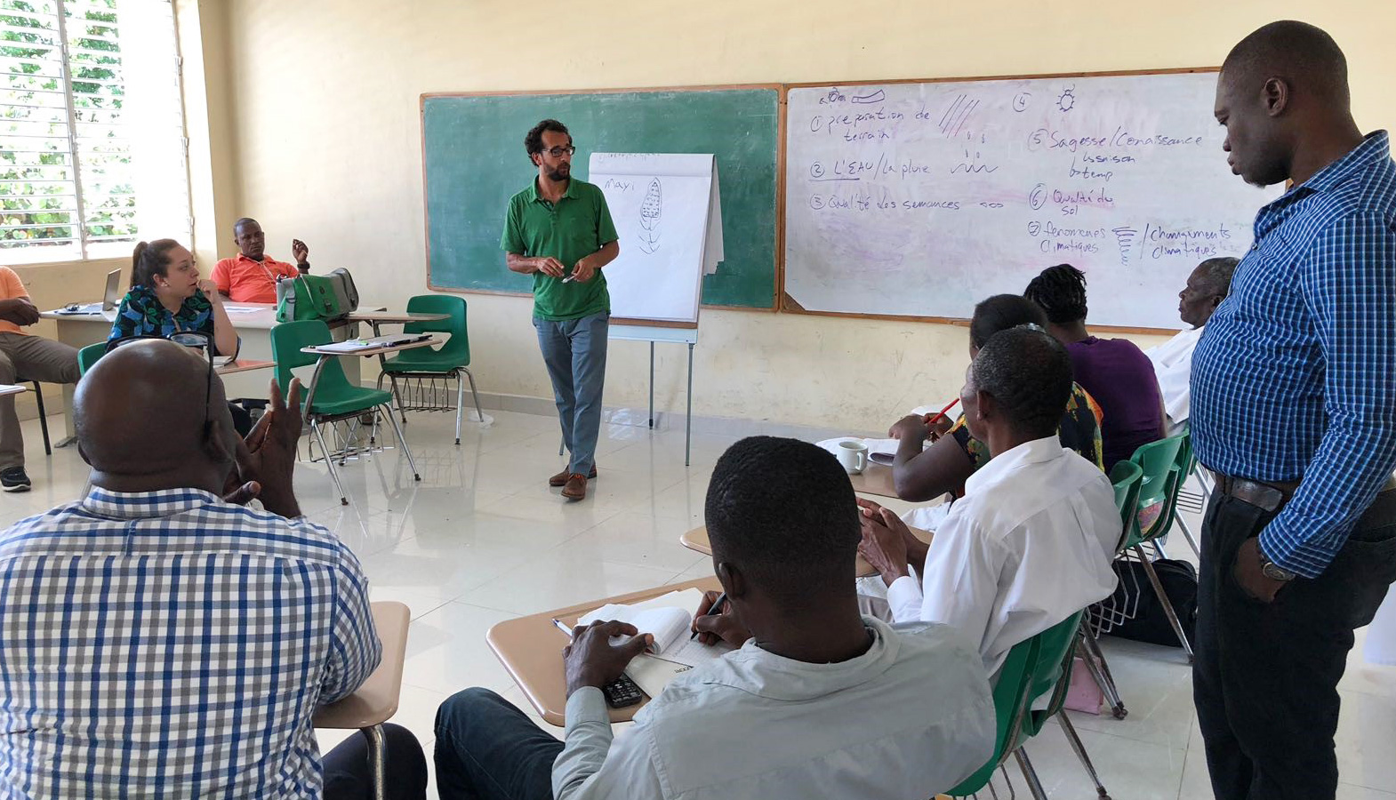 Dr. Julian Portilla, Director of Champlain's Center for Mediation & Dialogue, mediates a dispute between farmers displaced by an industrial plant built by the Haitian government after the 2010 earthquake.