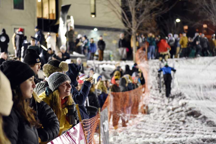 students looking on at the others participating in the rail jam