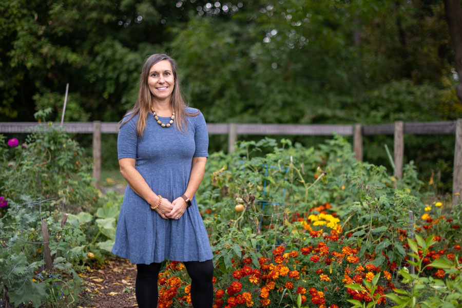 Dr. Valerie Esposito standing in champlain's community garden