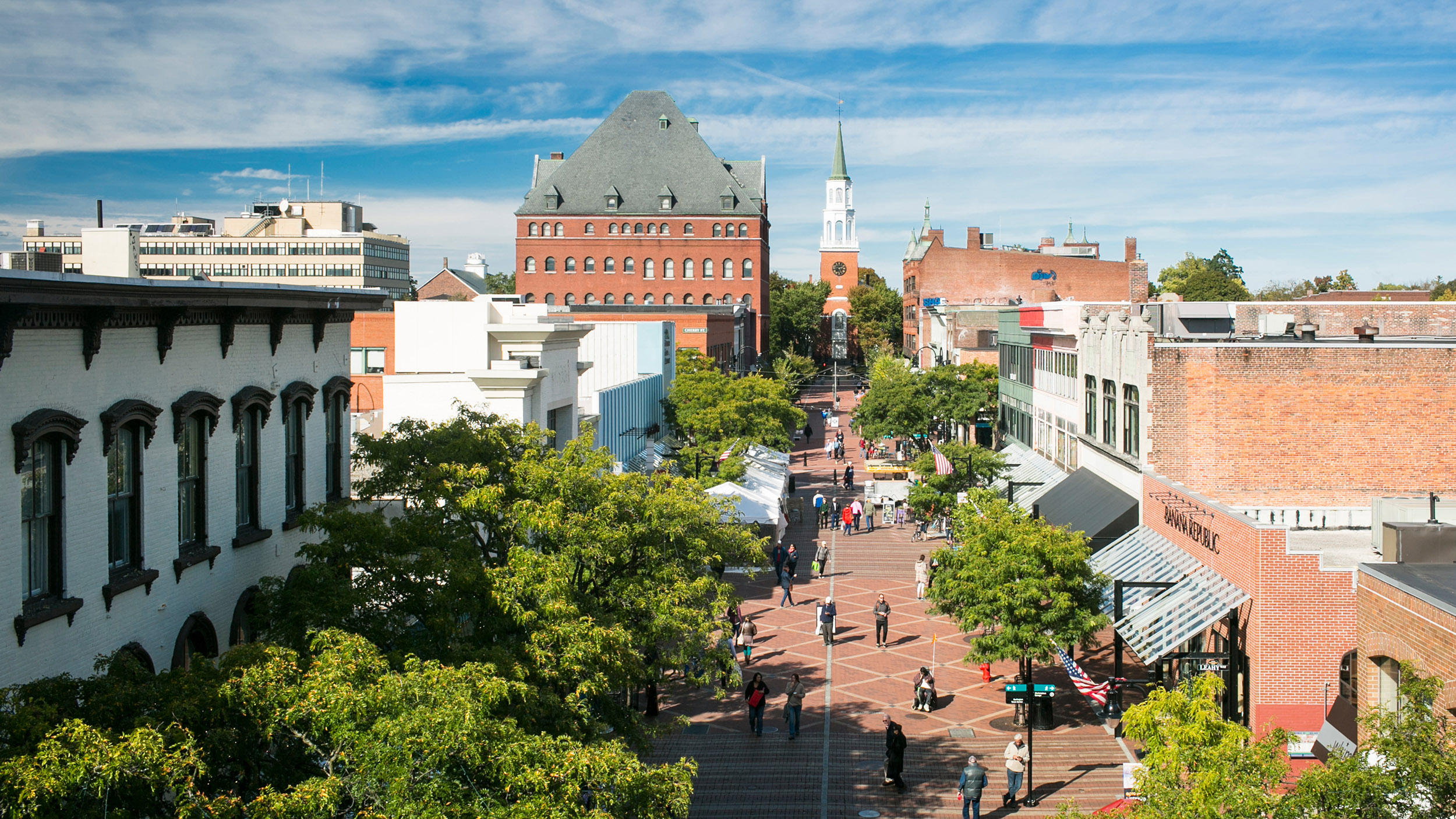 A high-angle view of church street in Burlington with people walking down the cobblestone
