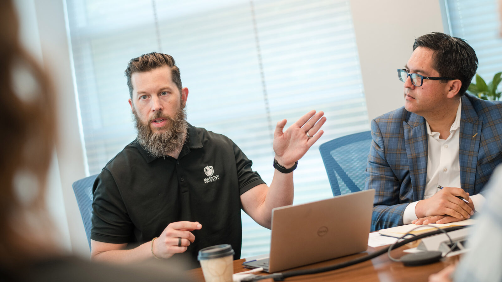 Justin Fimlaid of NuHarbor Security talks with President Hernandez and others