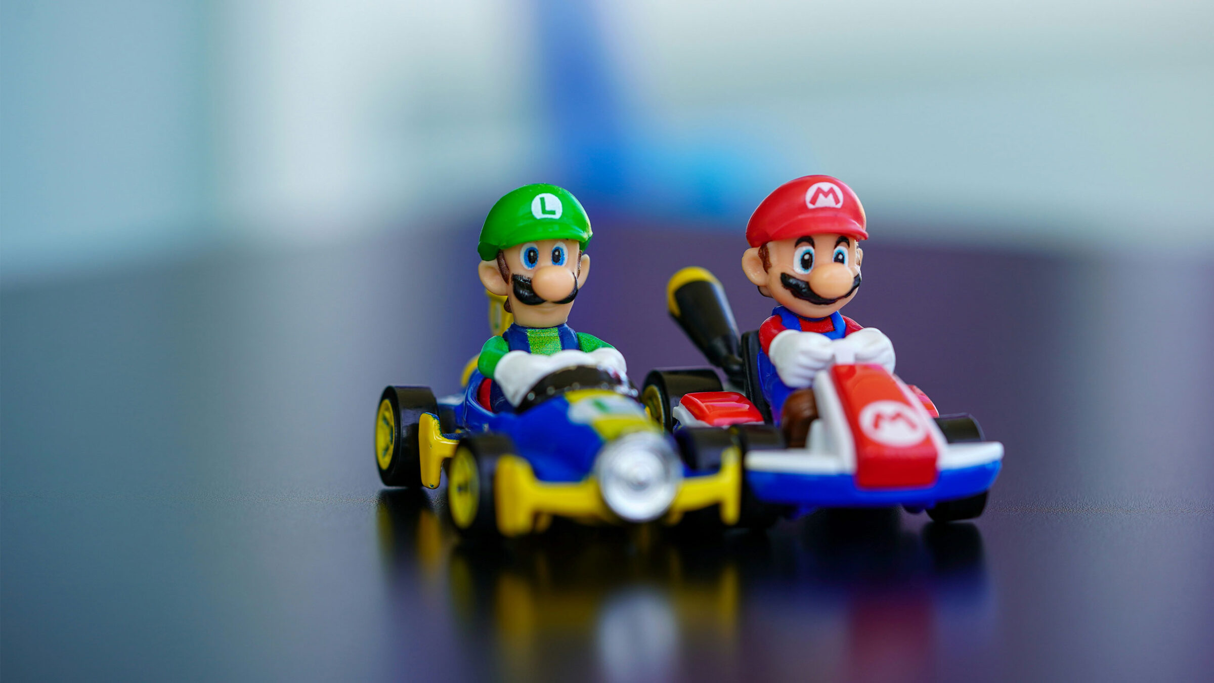 figures of Mario and Luigi in racing Karts on a table