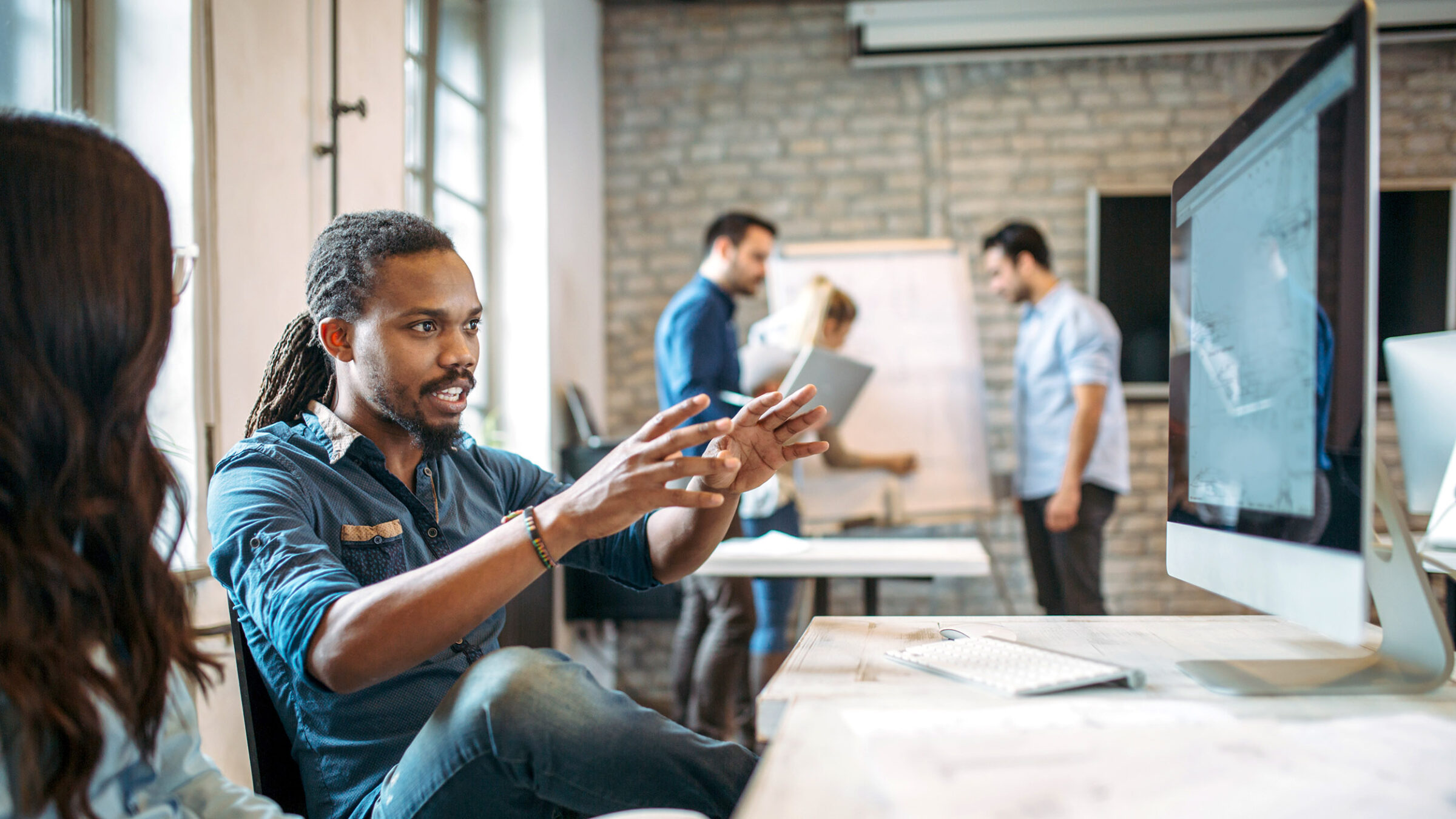 Young professionals working on project in office together