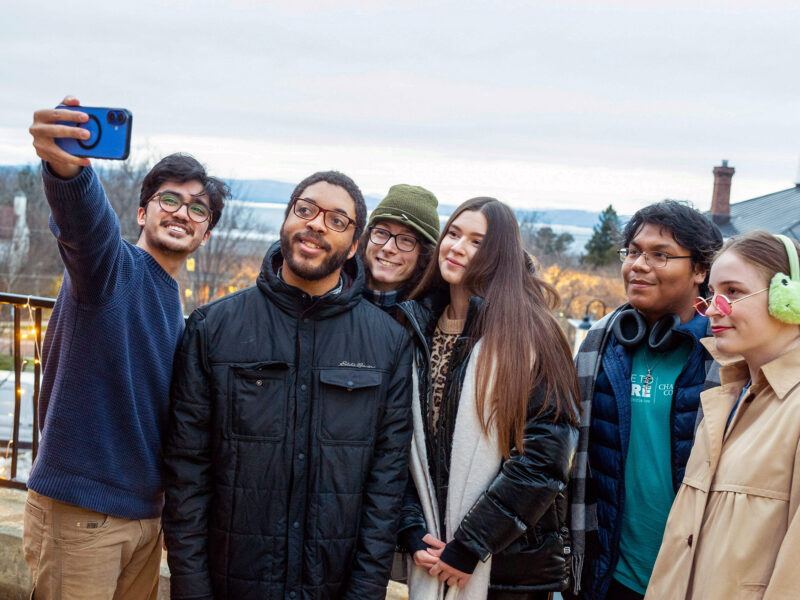 Students taking a selfie on campus in the winter
