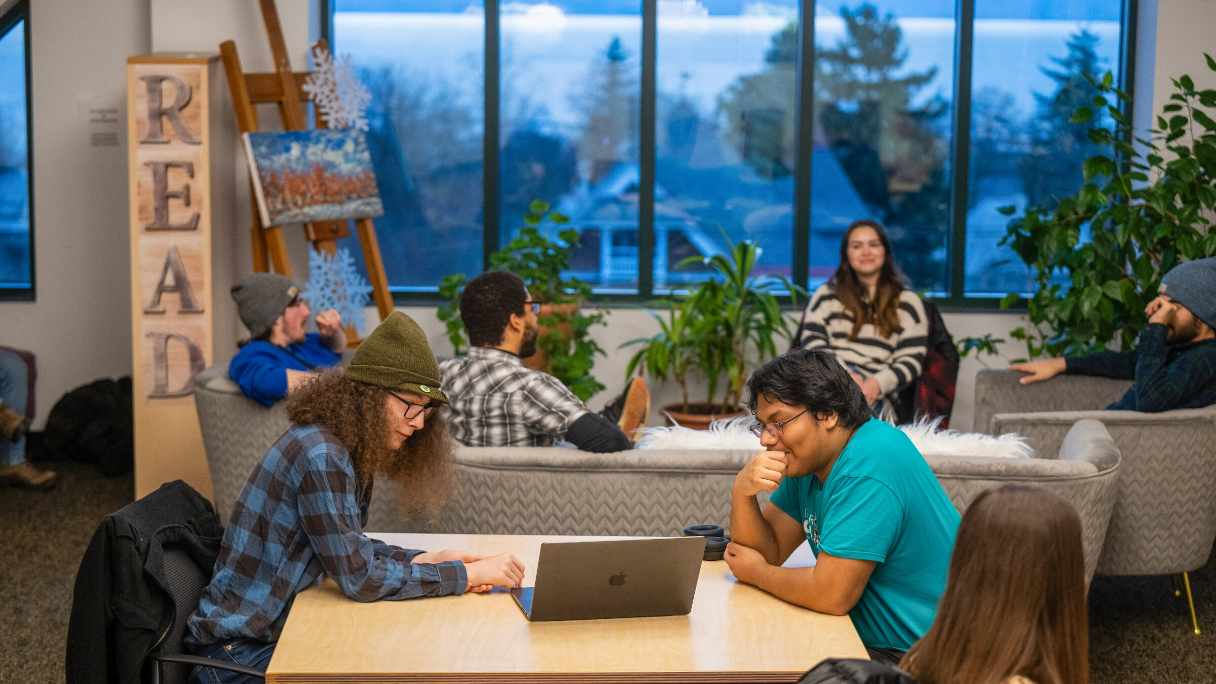 Students working in a communal lounge space