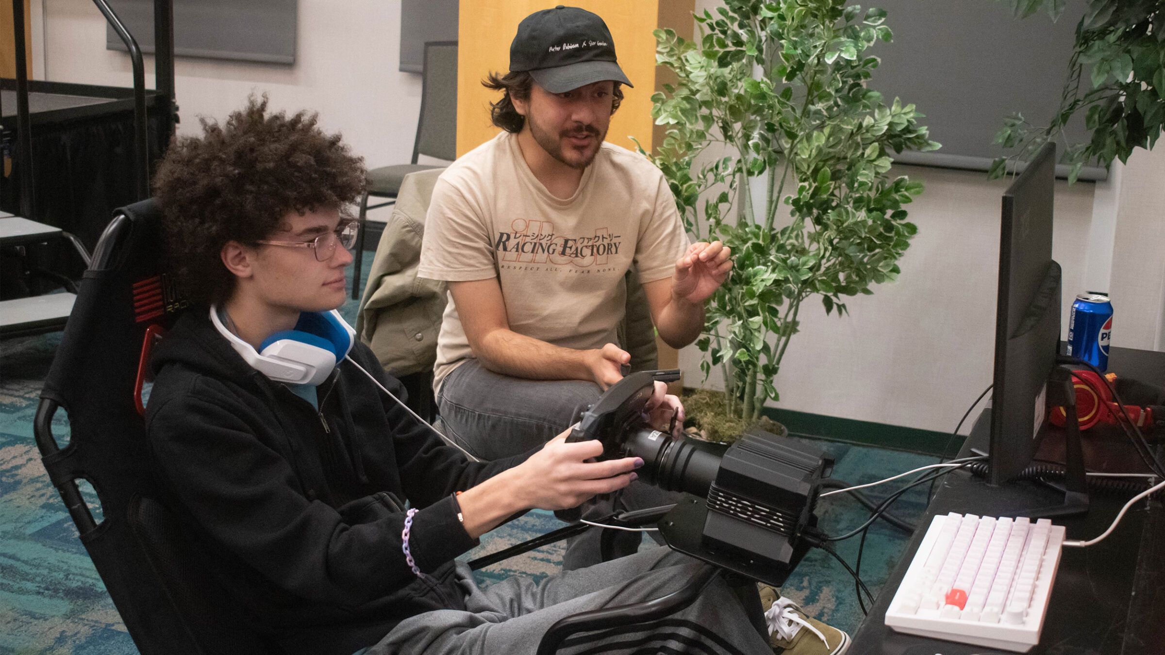 a student is simracing while another student watches
