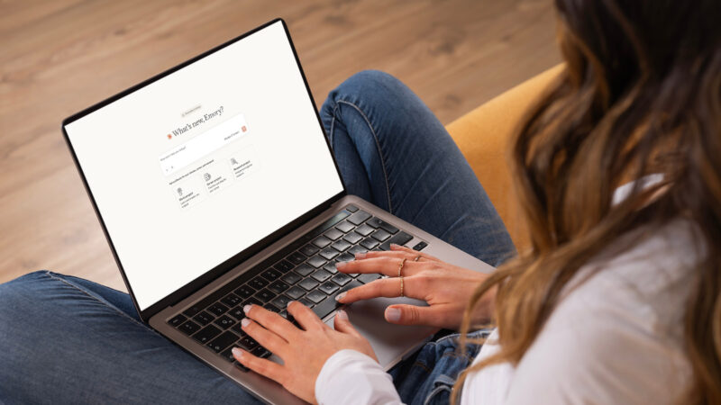 Over shoulder laptop claude welcome screen, young caucasian brunette