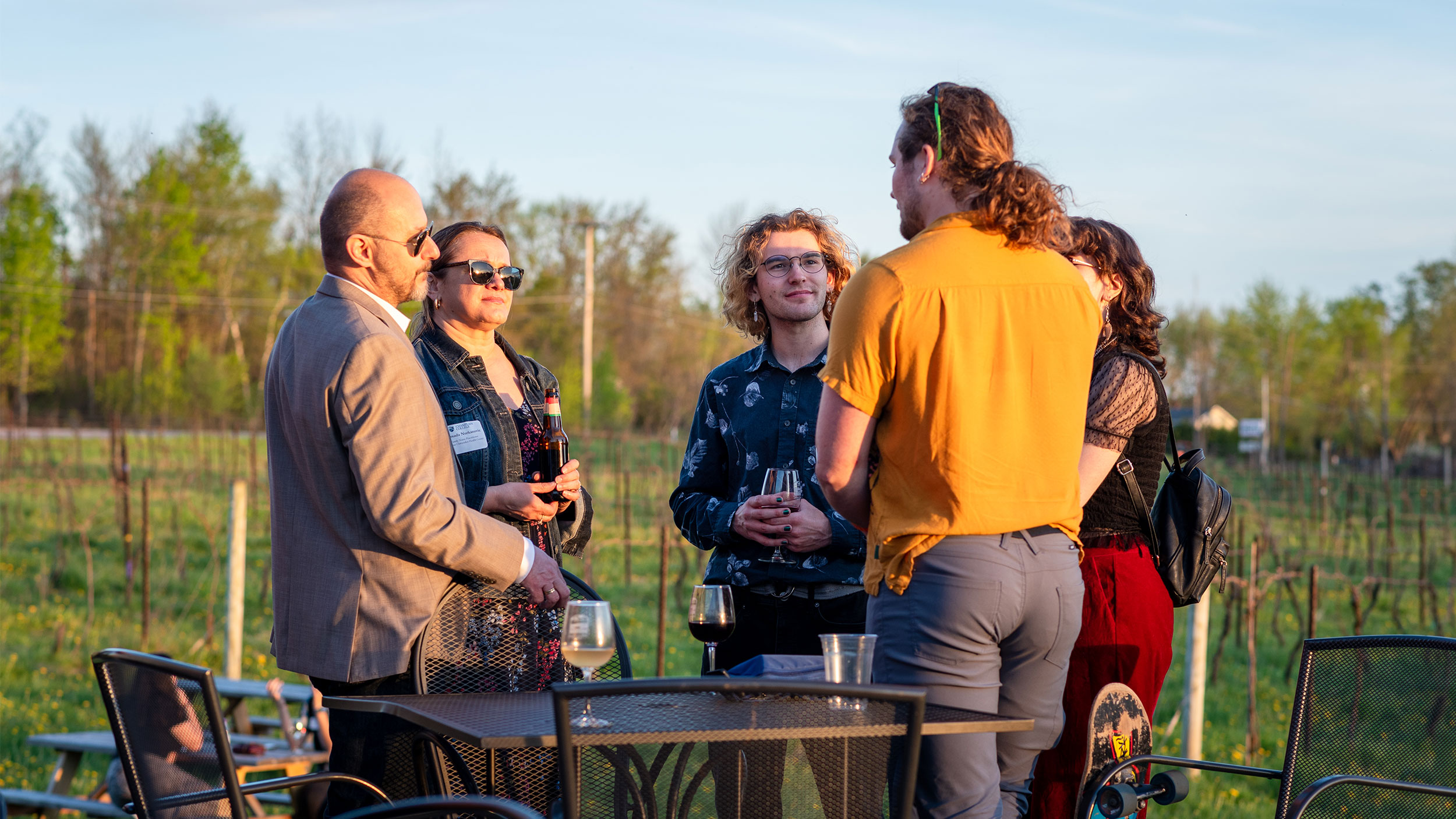 alumni and students network at a local vineyard