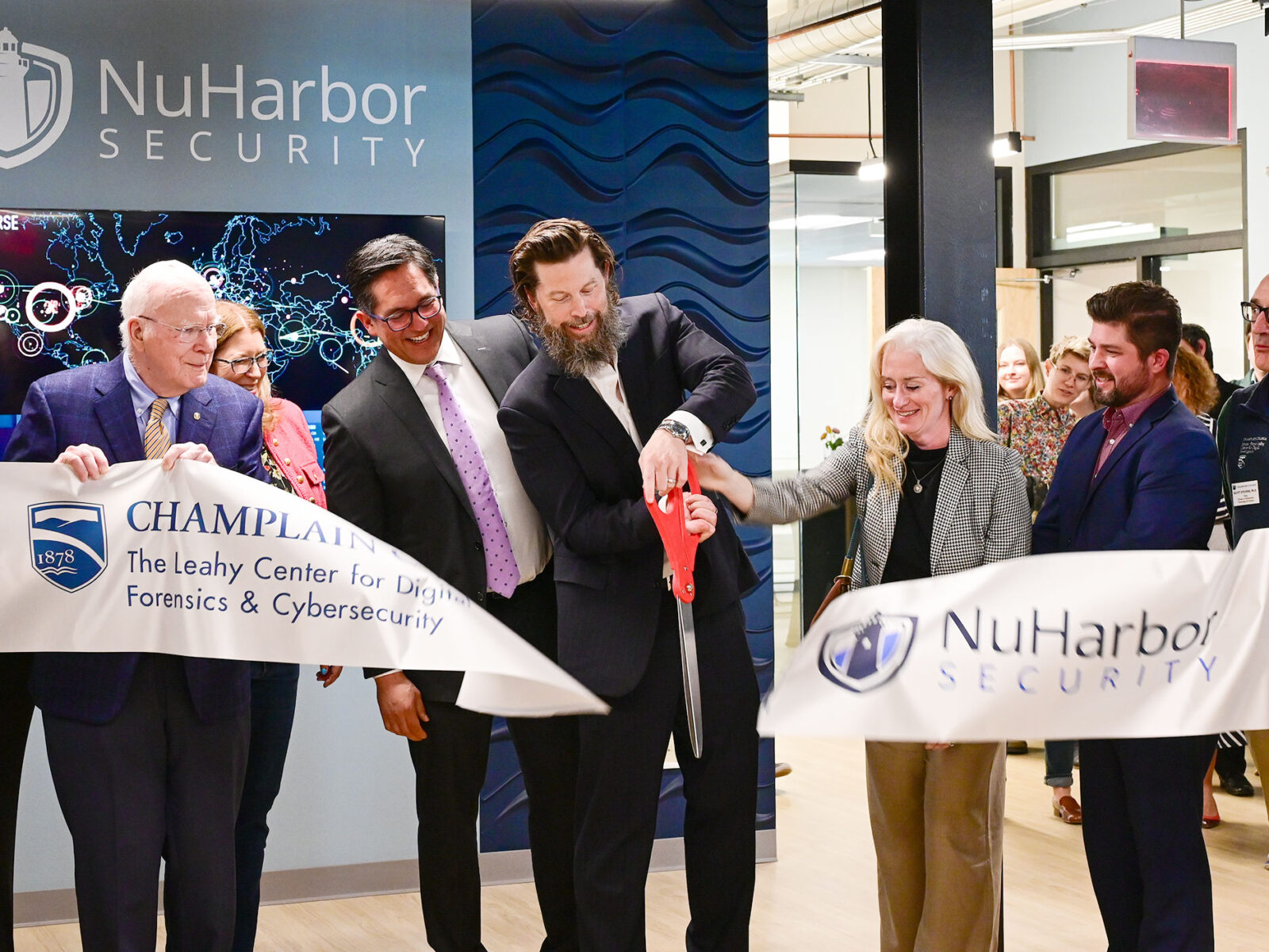 Senator Leahy, NuHarbor Security and Champlain College leadership cut the ribbon at a facility's grand opening.
