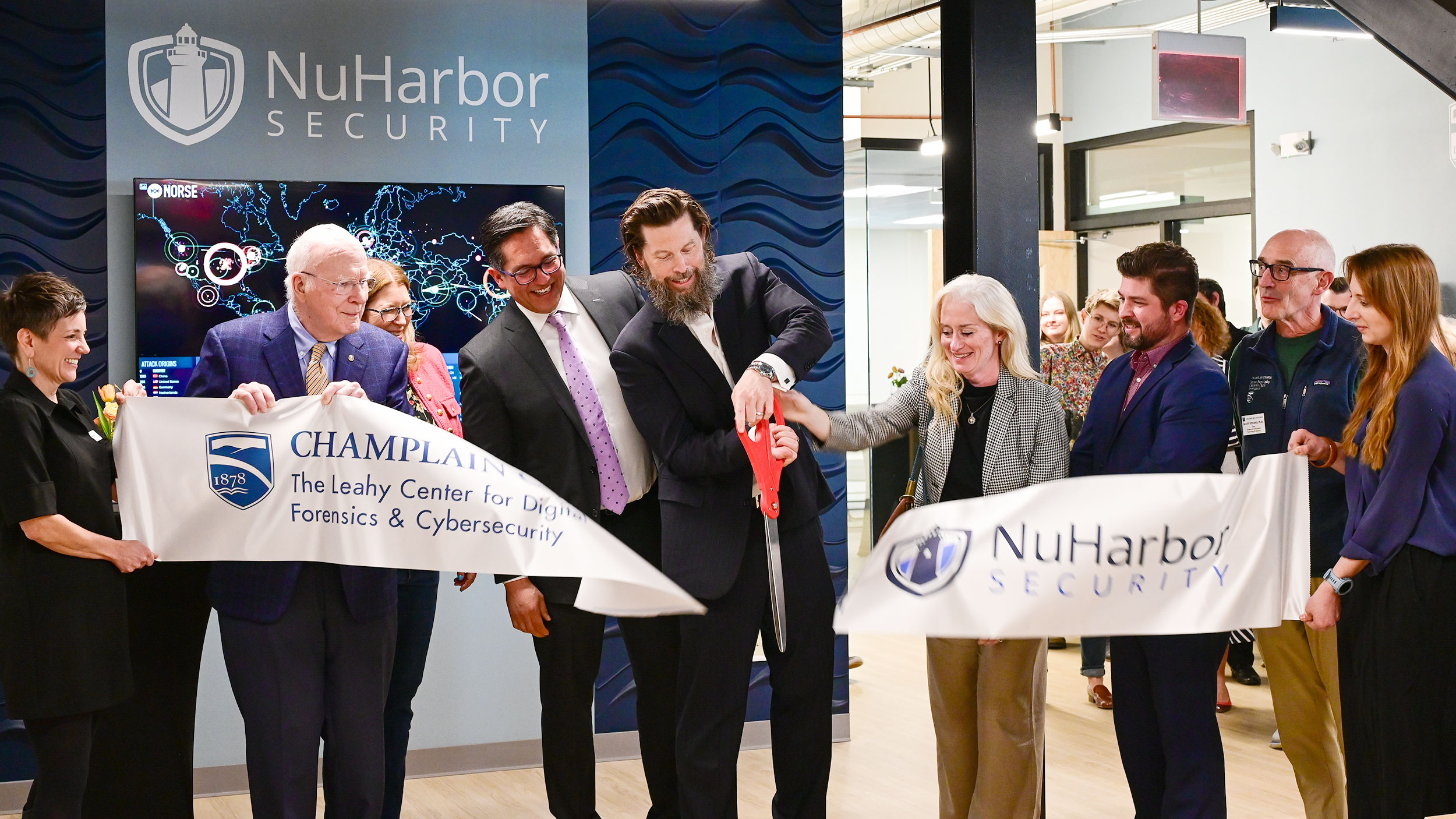 Senator Leahy, NuHarbor Security and Champlain College leadership cut the ribbon at a facility's grand opening.