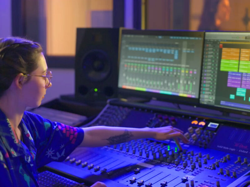 Student mixing audio using professional equipment