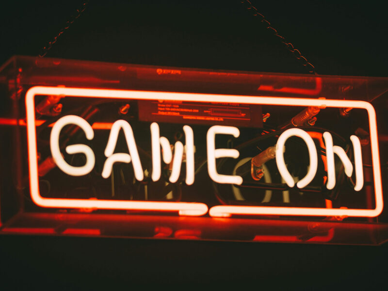 red light up sign that says "game on"