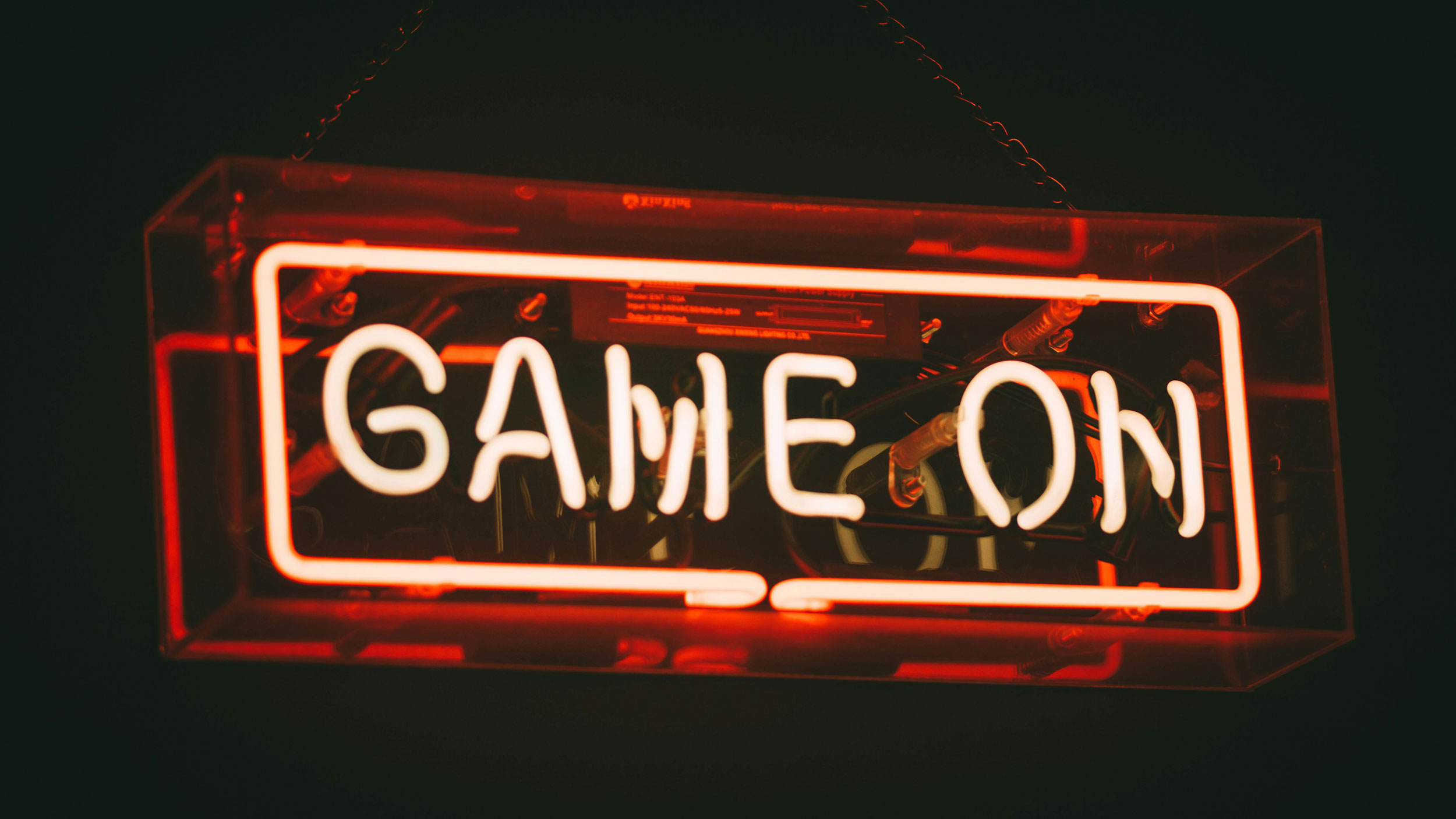 red light up sign that says "game on"