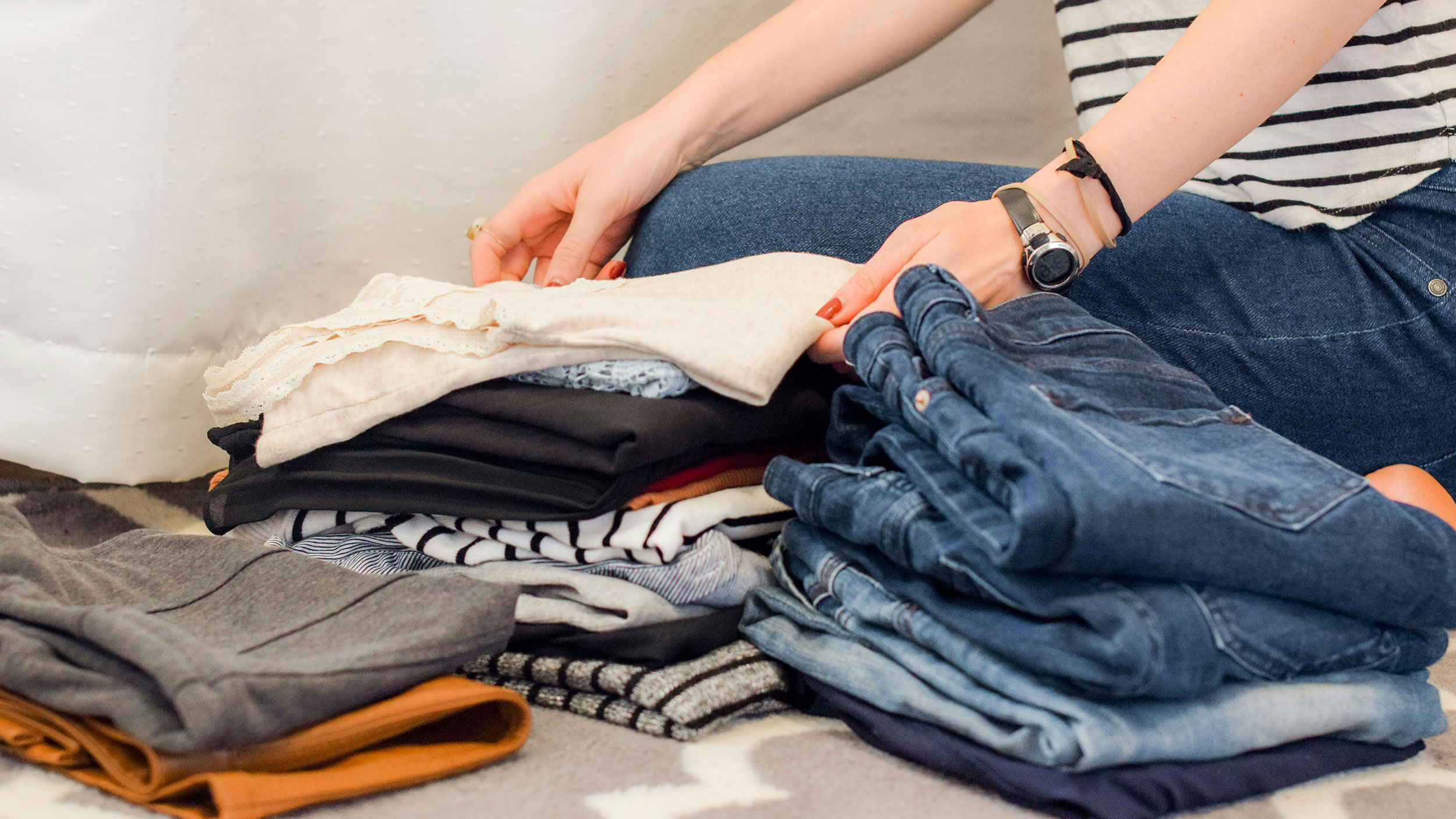 jeans and clothes piled on the floor