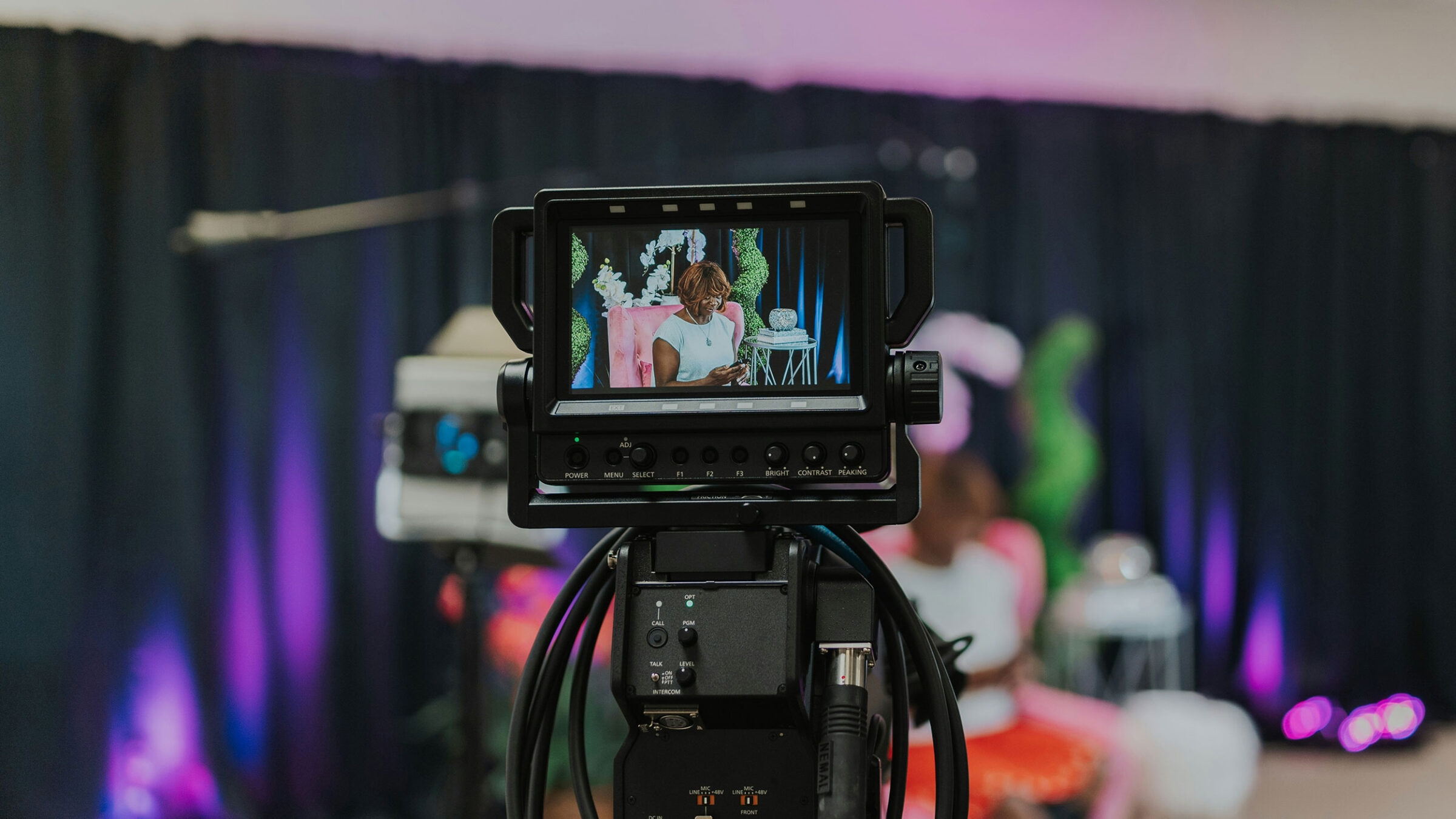a camera films a person sitting in a chair