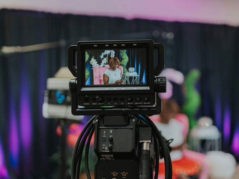 a camera films a person sitting in a chair