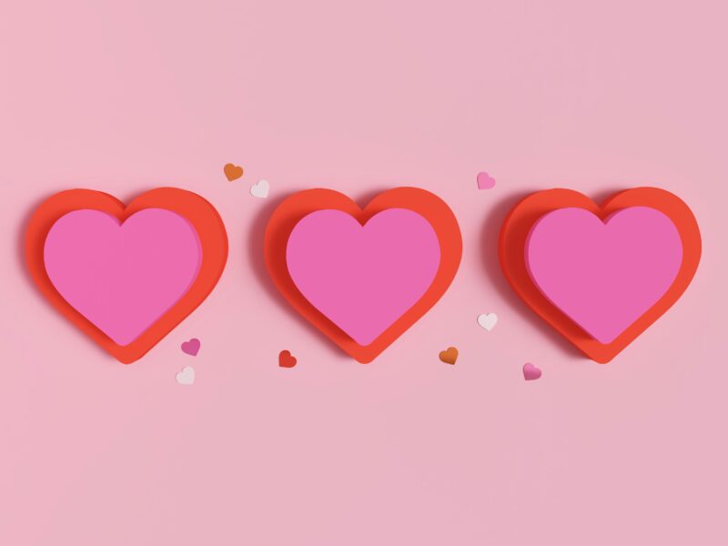 three paper red and pink hearts